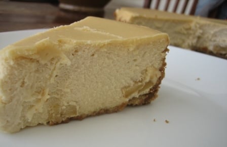 Slice of brown sugar apple cheesecake on a white plate.