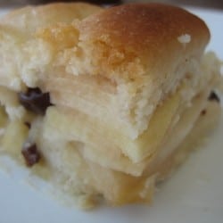 Slice of apple pie cake with alternating apple and crust layers on a white plate.
