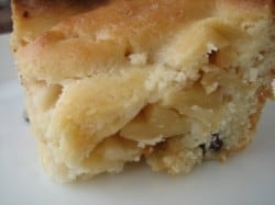 Slice of apple pie cake with alternating apple and crust layers on a white plate.