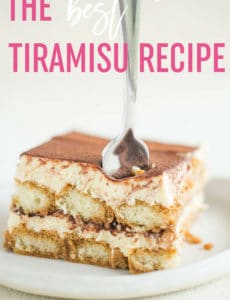 A slice of tiramisu on a white plate with a fork sticking out of the top and the words the best tiramisu recipe at the top.