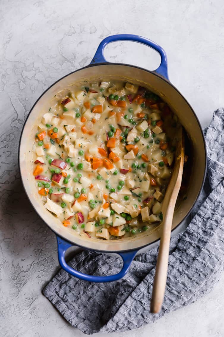 A blue pot with chicken pot pie filling.