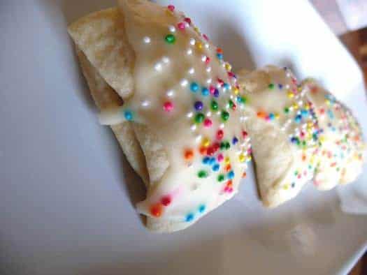 Italian fig cookies with sprinkles on a white plate.