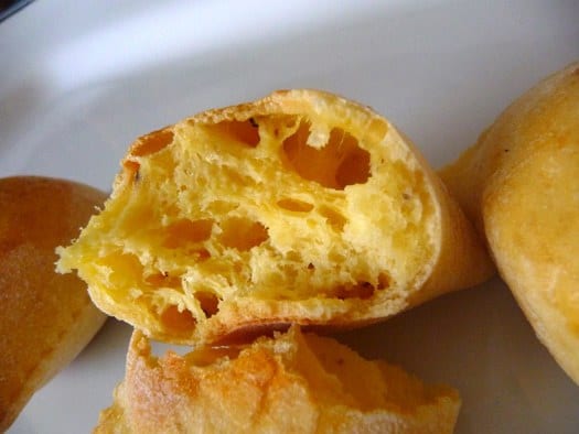Italian gougeres broken in half showing the inside texture.