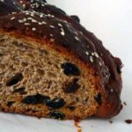 Loaf of Christopsomos with a slice removed showing the texture.