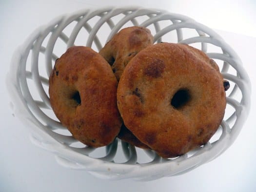 Cinnamon raisin bagels in a white bowl.