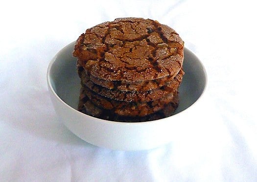 Stack of ginger cookies in a white bowl.