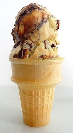 Ice cream cone with 2 scoops of tin roof ice cream.
