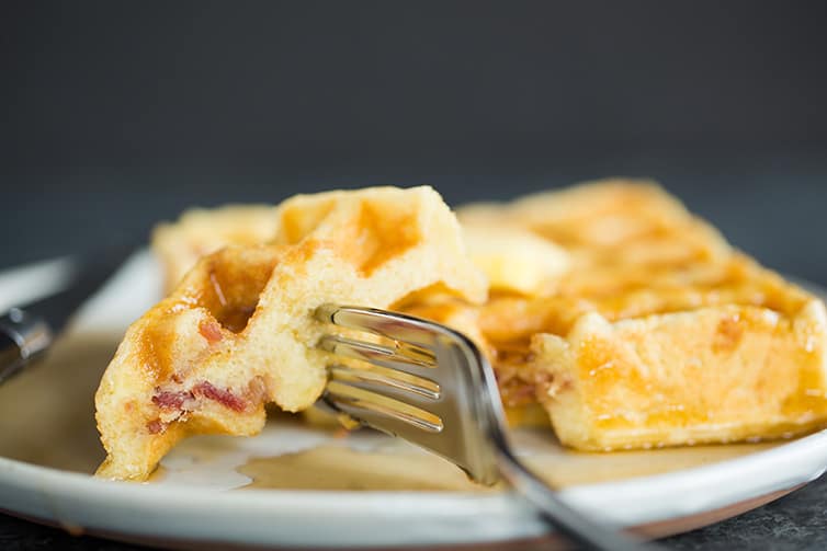 Taking a big bite of Brown Sugar-Bacon Buttermilk Waffles