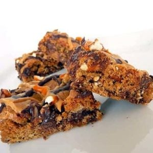 Chocolate chip and pretzel cookie bars on a white plate.