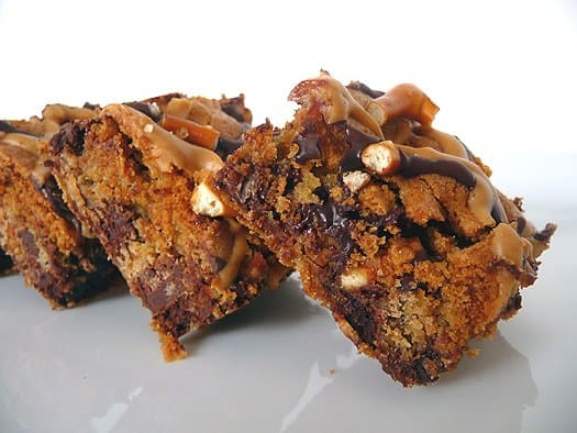 Chocolate chip and pretzel cookie bars on a white plate.