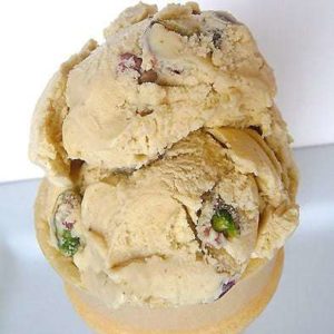 2 scoops of pistachio nut ice cream in an ice cream cone.
