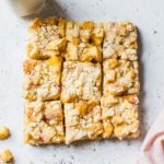 Peach crumb bars cut into nine squares.