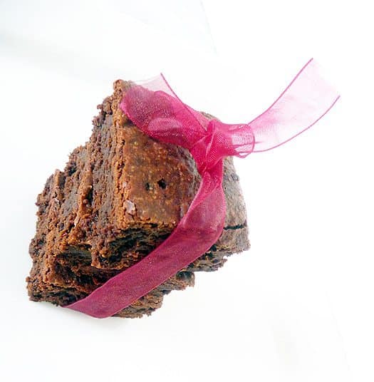 Stack of 4 brownies tied with a pink ribbon.