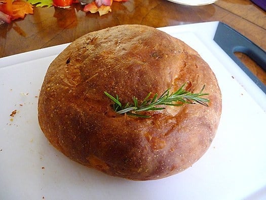 Loaf of potato rosemary bread with a sprig of rosemary.