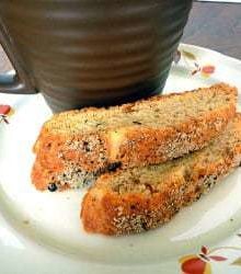 2 pieces of Parmesan black pepper biscotti on a white plate.