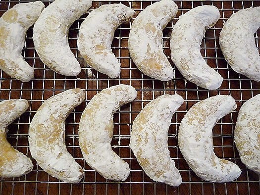 Nut crescent cookies on a cooling rack.