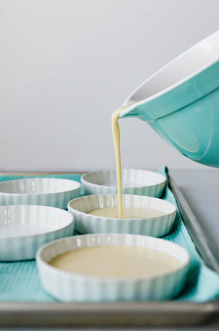 Pouring the custard into ramekin bowls for creme brulee.