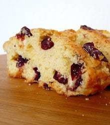 2 slices of cranberry white chocolate almond biscotti on a counter.