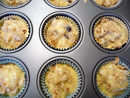 Raisin Bran muffin batter in a muffin pan before baking.