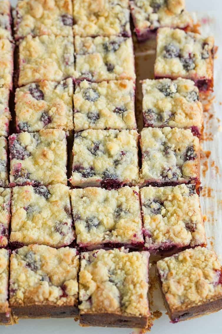 A pan of blackberry pie bars cut into squares.