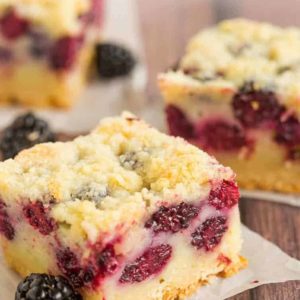 Three blackberry pie bars cut into squares.