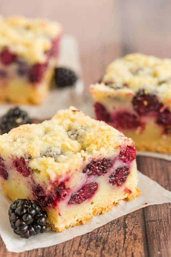 Three blackberry pie bars cut into squares.