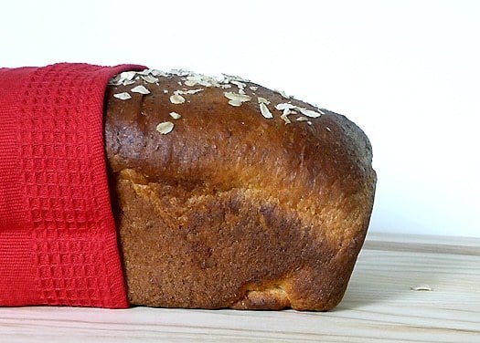 Side view of a loaf of honey oatmeal sandwich bread.