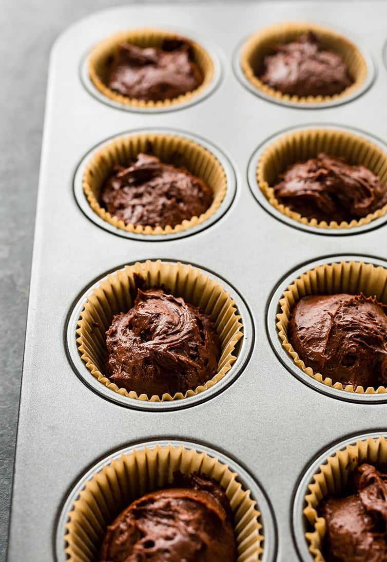 Chocolate cupcake batter in muffin cups before going into the oven.