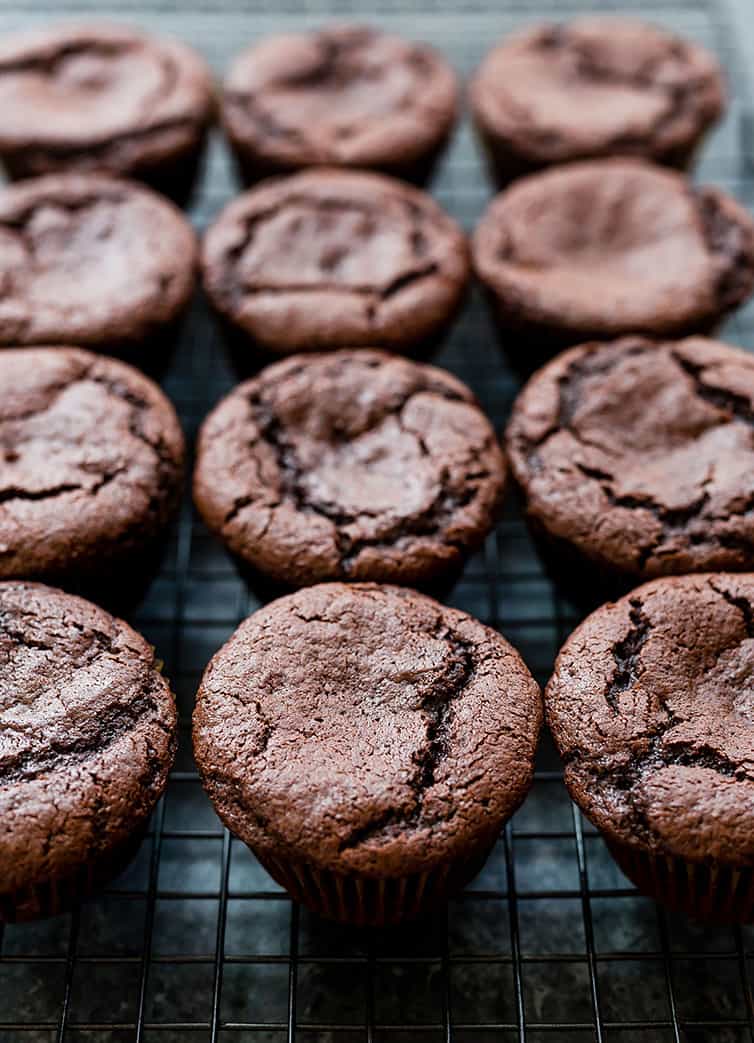 Baked chocolate cupcakes on a cooling rack.
