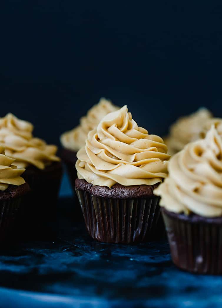 A display of chocolate cupcakes with peanut butter frosting.
