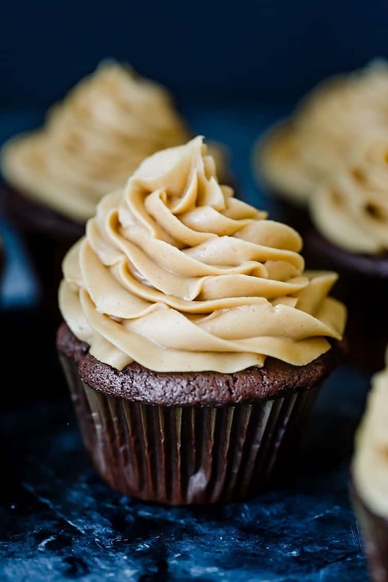 A display of chocolate cupcakes with peanut butter frosting.