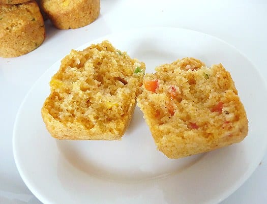 Corn muffin with peppers cut in half on a white plate.