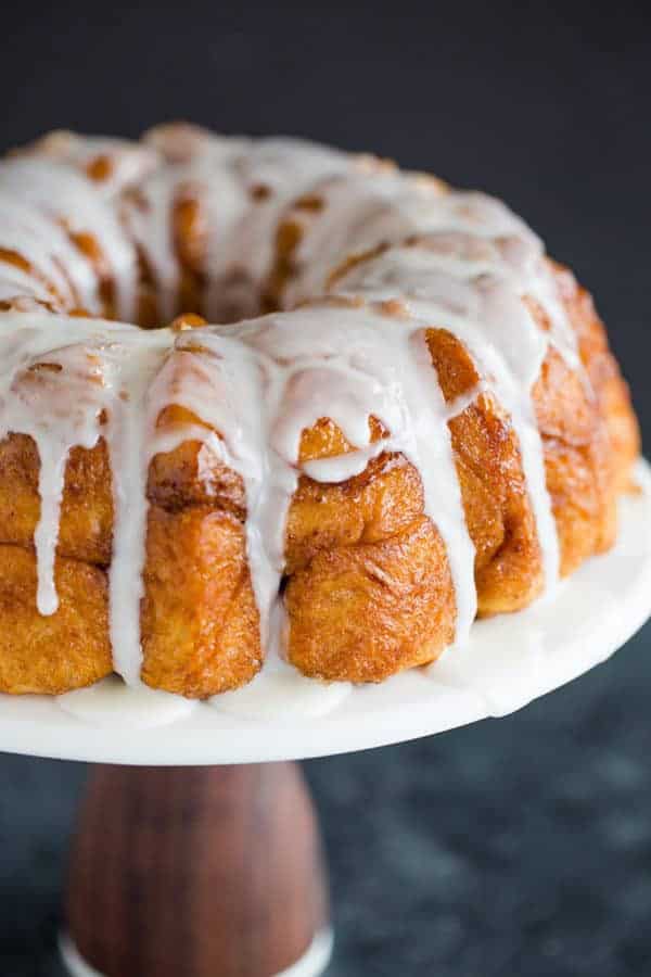 Baked and glazed monkey bread on a cake pedestal.
