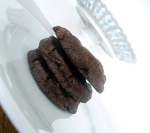 Stack of 3 salted chocolate shortbread cookies on a white plate.