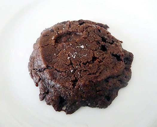 A salted chocolate shortbread cookie on a white plate.