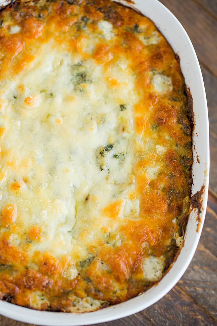 Overhead shot of a pan of baked spinach artichoke dip.