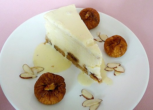 Slice of fig and almond cheesecake on a white plate.
