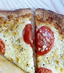 2 slices of white Sicilian pizza on a wood surface.