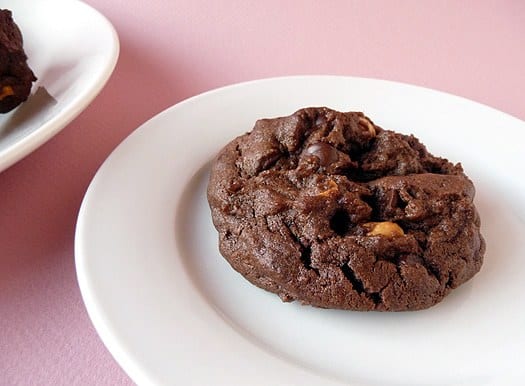 A salted double chocolate peanut butter cookie on a white plate.