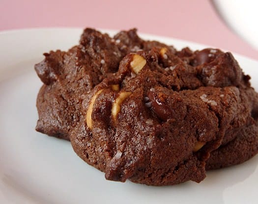 A salted double chocolate peanut butter cookie on a white plate.