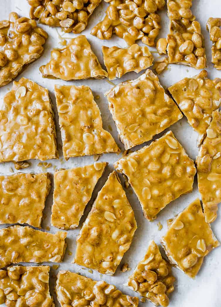 An overhead shot of peanut brittle broken into pieces.