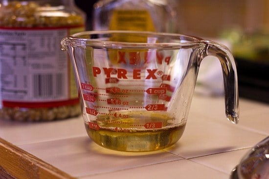 Cooking oil for popcorn in a glass measuring cup.
