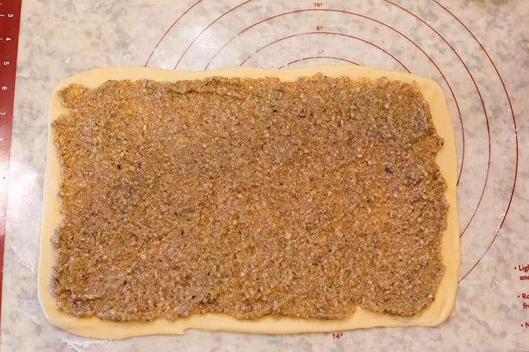 Nut filling spread on rolled out dough.