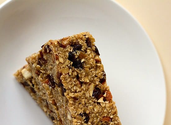 Overhead image of a stack of homemade granola bars on a white plate.