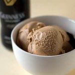 Scoops of Guinness milk chocolate ice cream in a white bowl with a spoon.