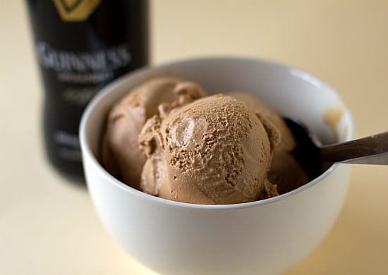Scoops of Guinness milk chocolate ice cream in a white bowl with a spoon.