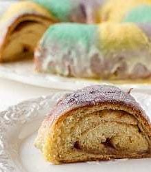 Slice of king cake on a white plate.