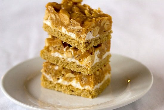 Stack of 3 salted peanut chew bars on a white plate.