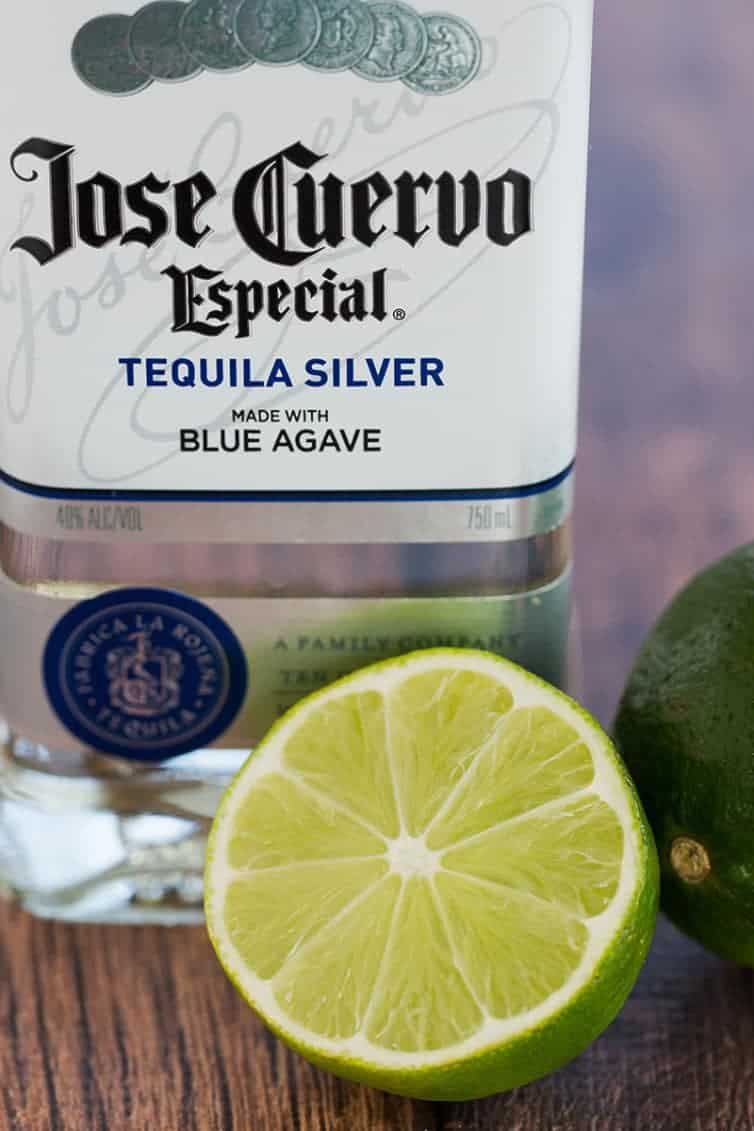 Prep for margarita cupcakes: a bottle of silver tequila and halved lime.