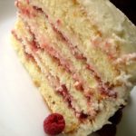 Slice of perfect party layered cake on a white plate.